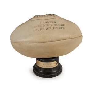 CARLTON'S RECORD VFL SCORE: Carlton met Hawthorn in Round 2 of the 1969 season. Carlton won the match, booting 30.30.210 against Hawthorn's 12.10.82. A commemorative trophy featuring a miniature white leather ball displayed on a bakelite stand with an eng