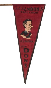 ESSENDON: red and black pennant with portrait caricature of John Coleman in his Essendon jumper titled "ESSENDON'S GOAL CHAMP J COLEMAN OF THE DONS", circa 1950, 42cm long, mounted on original wooden stick. The only example known to us. 
