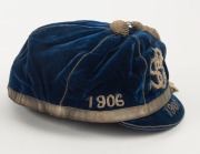 A deep blue velvet honour cap with silver metallic tassel and band around lower edge; silver metal thread "1906 SLSC 1907" applied to three front panels and "1907" also to peak; maker's label for "Farmer & Company Limited, Sydney" to the inner peak. Super - 2