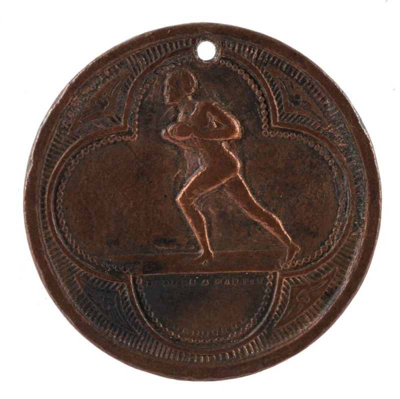 1886 Football Medal, showing on front a footballer running with ball in hand and "Stokes and Martin, Melbourne"; verso with "Victoria 1886" with leaves between the word and the date with a blank centre; hold at top. Believed to be associated with an inter