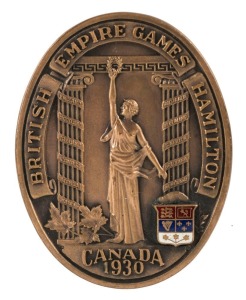 1930 BRITISH EMPIRE GAMES, HAMILTON, CANADA, a bronze and enamel participation medal in the maker's presentation box (Klein & Binkley, Hamilton, Can.); the oval shaped medal 39 x 50cm. Accompanied by a small annotated photograph album "To E.J. Holt, Souvenir of the British Empire Games, Hamilton (Ont.) Canada, August 1930". E.J.H. Holt was Honorary Secretary of the A.A.A. and in 1938 became Honorary Secretary of the I.A.A.F.