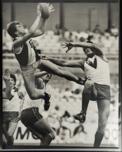 SPECTACULAR MARKS: An album of 1970s-2000s large format photographs (mainly 20 x 30cm) featuring spectacular action shots of players in mid-leap above their team mates and opponents. Players featured include Barker, Silvagni, Modra, Teasdale, Moorcroft, e