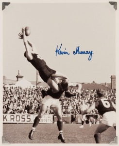 KEVIN MURRAY, original signature on a photograph of him taking an iconic mark, as he climbs high over Melbourne’s Ron Barassi at Brunswick Street Oval in 1961. 25 x 20cm.