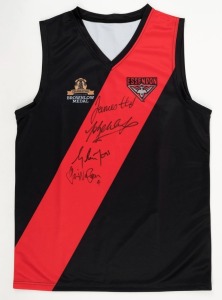 ESSENDON: Celebrating The History of the Brownlow Medal souvenir club jersey signed by winners Graham Moss, Gavin Wanganeen, James Hird and Jobe Watson.