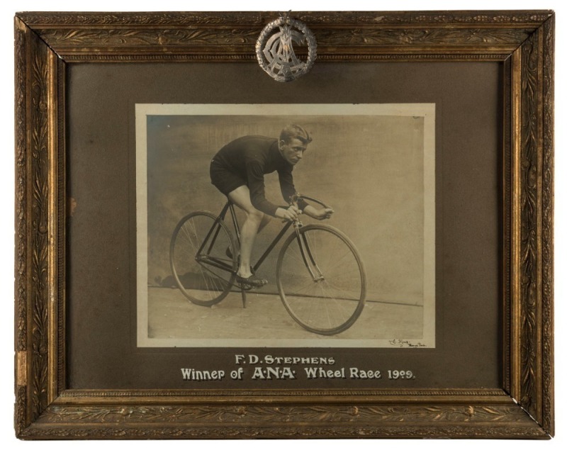 "F. D. STEPHENS Winner Of  A. N. A Wheel Race 1909", black and white albumen photograph framed and mounted with caption, and accompanying silver trophy plaque. Photograph by Kemp of Moonee Ponds. 58cm x 74cm overall