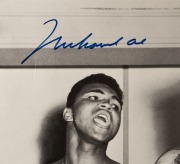 Muhammad Ali, signed b/w photograph of Ali at weigh-in with Sonny Liston, 41 x 51cm. Muhammad Ali (then known as Cassius Clay) taunts Sonny Liston during their weigh-in before the World Heavyweight Title fight on 25th February 1964. Clay won, in a seventh - 2