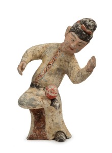 A Chinese pottery statue of a male figure with ball, remains of polychrome finish, Tang Dynasty 618 to 907 A.D. Accompanied by a thermoluminescence test certificate from the Oxford Authenticity, United Kingdom, (HK 2123-687). 38cm high