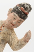 A Chinese pottery statue of a male figure with ball, remains of polychrome finish, Tang Dynasty 618 to 907 A.D. Accompanied by a thermoluminescence test certificate from the Oxford Authenticity, United Kingdom, (HK 2123-687). 38cm high - 2