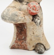 A Chinese pottery statue of a male figure with ball, remains of polychrome finish, Tang Dynasty 618 to 907 A.D. Accompanied by a thermoluminescence test certificate from the Oxford Authenticity, United Kingdom, (HK 2123-687). 38cm high - 3
