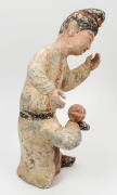 A Chinese pottery statue of a male figure with ball, remains of polychrome finish, Tang Dynasty 618 to 907 A.D. Accompanied by a thermoluminescence test certificate from the Oxford Authenticity, United Kingdom, (HK 2123-687). 38cm high - 4