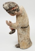 A Chinese pottery statue of a male figure with ball, remains of polychrome finish, Tang Dynasty 618 to 907 A.D. Accompanied by a thermoluminescence test certificate from the Oxford Authenticity, United Kingdom, (HK 2123-687). 38cm high - 6