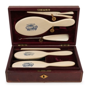 An antique English ivory travelling grooming set in fine scarlet leather box, 19th century, ​​​​​​​8cm high, 27cm wide, 17cm deep