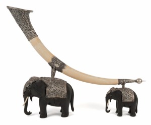 An antique Indian silver mounted ivory ornament resting on two carved ebony elephants, 19th century, an impressive 51cm high, 74cm long
