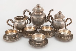 A Vietnamese silver tea set comprising a teapot, milk jug and sugar basin, together with five cups and saucers, 20th century, ​​​​​​​the teapot18cm high, 1930 grams