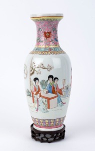 144 · A Chinese famille rose porcelain vase with scene of women in a garden setting, with carved wooden stand, 20th century, seal mark to base, ​34cm high