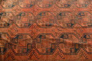 TURKMEN RUG: Hand knotted red & black geometric patterned vintage rug of impressive proportions. 5.6m x 3.9m