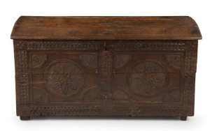 An antique oak dome-top trunk with carved front, 18th century, 68cm high, 124cm wide, 62cm deep