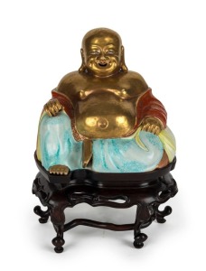 An antique Chinese porcelain Buddha statue on a fine carved wooden stand, Qing Dynasty, early 19th century, 27cm high overall