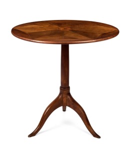 An antique French walnut tilt-top occasional table with segmented top, satinwood paterae, cylinder trunk and tripod base, 19th century, 74cm high, 71cm diameter