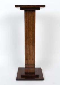 An Art Deco oak pedestal with square top, conforming base and a fluted trunk, circa 1930, 80.5cm high, 30.5cm wide, 30.5cm deep