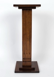 An Art Deco oak pedestal with square top, conforming base and a fluted trunk, circa 1930, ​​​​​​​80.5cm high, 30.5cm wide, 30.5cm deep