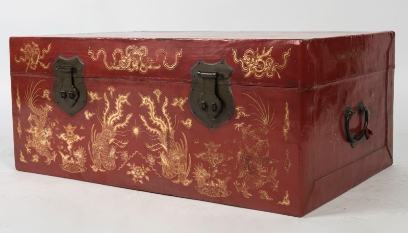 A Chinese red lacquered trunk with hand-painted gilded highlights, 20th century, 33cm high, 78cm wide, 52cm deep