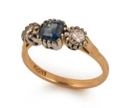 An antique 15ct yellow gold ring, set with a blue sapphire, flanked by two diamonds, mounted in platinum, 19th century, stamped "15ct", ​​​​​​​3.7 grams