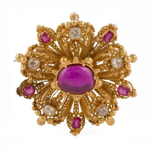 An antique 18ct yellow gold cannetille brooch with cabochon ruby surrounded by old mine cut diamonds and rubies, early 20th century, ​​​​​​​3cm wide, 9.1 grams