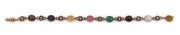 An Edwardian multi-coloured gemstone and diamond bracelet mounted in 18ct yellow gold and platinum, circa 1910. Set with cabochon sapphires, natural emerald, garnet, tourmaline and moonstone. ​​​​​​​18cm long - 2