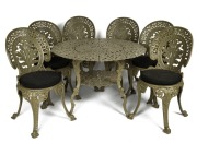 A cast iron garden table with six Coalbrookdale style cast iron chairs, all with olive green painted finish, 19th/20th, (7 items), the table 65cm high, 98cm wide