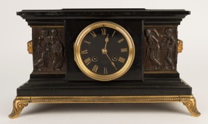 An antique French mantle clock in black slate case with figural bronze decoration and gilt metal mounts, eight day time and strike movement with Roman numerals, 19th century, 27cm high, 35cm wide