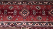 Three red patterned rugs, ​​​​​​​the largest 121cm long - 2
