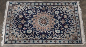 A Persian hand-knotted rug with navy blue ground, 140 x 90cm