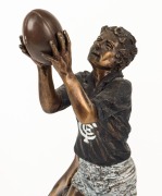 An impressive bronze statue on a black marble base, depicting a Carlton player taking a "screamer" over the shoulder of an Essendon player; overall 55cm high. - 2