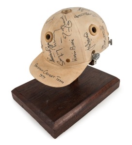 1979 PAKISTAN CRICKET TEAM: Match worn batting helmet signed by 15 members of the Pakistan touring party, attractively displayed on a custom built timber base. Accompanied by "The Pakistan Book of Test Cricket 1952-53 - 1982" by Abid and Masood as well as