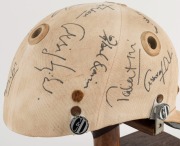 1979 PAKISTAN CRICKET TEAM: Match worn batting helmet signed by 15 members of the Pakistan touring party, attractively displayed on a custom built timber base. Accompanied by "The Pakistan Book of Test Cricket 1952-53 - 1982" by Abid and Masood as well as - 4