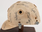 1979 PAKISTAN CRICKET TEAM: Match worn batting helmet signed by 15 members of the Pakistan touring party, attractively displayed on a custom built timber base. Accompanied by "The Pakistan Book of Test Cricket 1952-53 - 1982" by Abid and Masood as well as - 7