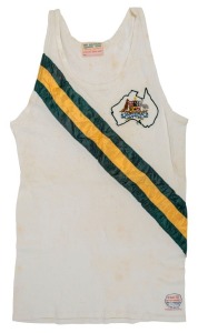 1956 SUMMER OLYMPICS - MELBOURNE: Official Team singlet made by Melbourne Sports Depot with the Australian Coat of Arms embroidered within a map of Australia and emblazoned with green and gold striped sash front and back. A rare survivor.