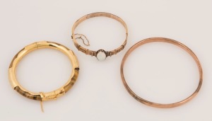 Three assorted antique bangles including 15ct gold and solid opal, rolled 9ct rose gold, and a gold mounted tiger's eye example, 19th/20th century, 