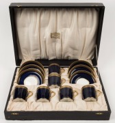 AYNSLEY boxed blue and white porcelain demi-tasse set with gilded highlights, retailed by WILLIAM DRUMMOND & Co. of Melbourne, green factory marks, the saucers 11cm diameter