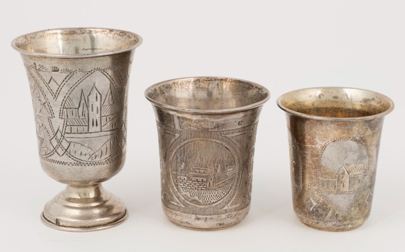 Three antique Russian silver beakers with engraved decoration, 19th century, the largest 8.5cm high