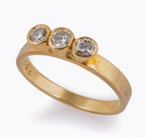 An 18ct yellow gold ring, set with a row of three white diamonds, 20th century, 3.2 grams