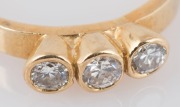 An 18ct yellow gold ring, set with a row of three white diamonds, 20th century, 3.2 grams - 2