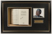 NELSON MANDELA (1918 - 2013) strong pen signature on the title page of his autobiography, "Long Walk to Freedom"; attractively box-framed in combination with a photograph and plaque, overall 41 x 63cm. Accompanied by a signed note dated May 2001 indicati