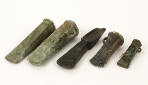 Five assorted bronze axe heads, unknown age and origin, the largest 14cm long