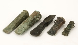 Five assorted bronze axe heads, unknown age and origin, the largest 14cm long