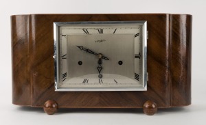 An English Art Deco walnut mantle clock with time and strike movement, retailed by Sir John Bennett, circa 1930s, ​​​​​​​23cm high, 45cm wide