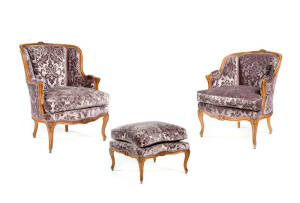 BERGERES: A pair of French purple upholstered carved walnut armchairs with matching ottomans