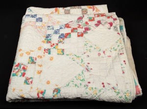 An antique American patchwork quilt, handmade in cream and pastel colours, early 20th century, 175cm x 200cm