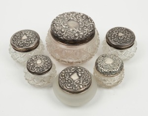 Group of six assorted crystal and sterling silver antique and vintage circular vanity jars, 19th/20th century, the largest 7cm high, 10cm wide